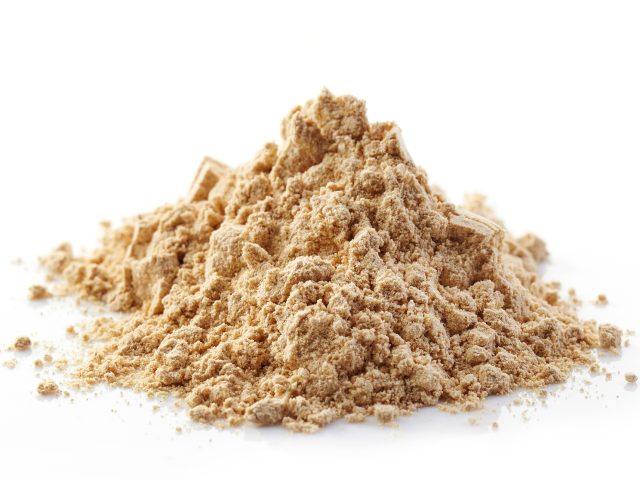 heap of maca powder isolated on white